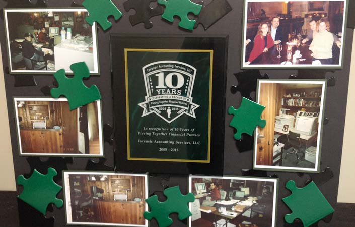 Poster board with green puzzle pieces and 1oth Anniversary plaque.